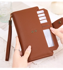 Detail view of brown RFID wallet with multiple card slots and clear ID window for women