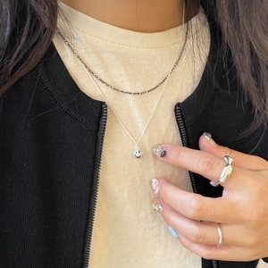 Sterling silver smiley face pendant necklace and black beaded chain set worn by model
