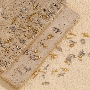 Minimalist 18K gold and silver plated stainless steel DIY letter pendants on beige stone