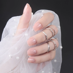 Short square light pink glossy press-on nails with silver rings and pearl mesh decor