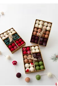 Detail of assorted wool felt Christmas balls in red and green with snowflake patterns
