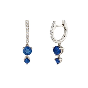 Detail of drop earrings with blue round-cut crystals and sparkling pavé hoops on white background