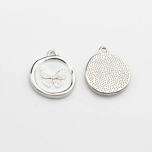 Detailed front and back view of silver butterfly pendants with inlaid zircons and pearls