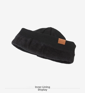 Close-up of winter knit hat showing thick black fleece lining and woven texture