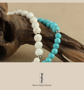 Detailed macro view of white and turquoise beaded phone straps on natural wood