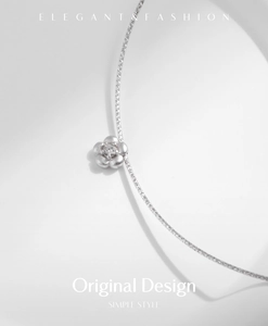 Close-up of s925 silver flower pendant with sparkling center stone on a delicate chain