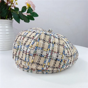 Close-up of multicolor plaid tweed beret showing textured weave and fabric detail