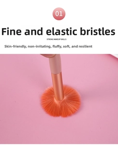 Close-up of soft orange makeup brush bristles showing fine texture and elasticity