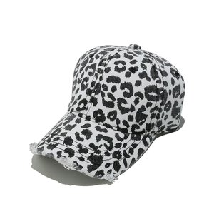 Detail of distressed brim and black leopard print on vintage baseball cap fabric
