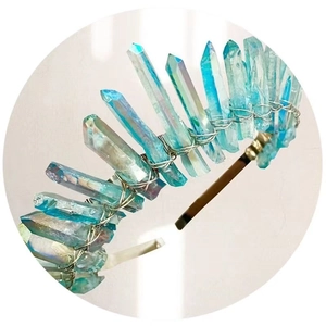 Close-up of handmade blue iridescent crystal crown with silver wire on metal headband