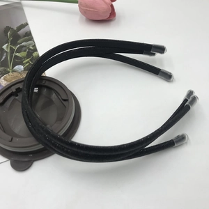 Close-up of black glitter headbands with protective caps on a white surface