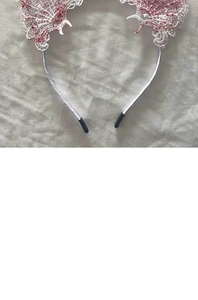 Close-up of white lace cat ear headband with bloody red stains for Halloween