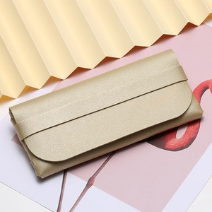 Champagne gold textured leather sunglass pouch with portable flap and strap closure