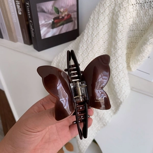 Close-up of tortoise shell butterfly hair claw clip with golden Sunshine Handmade text