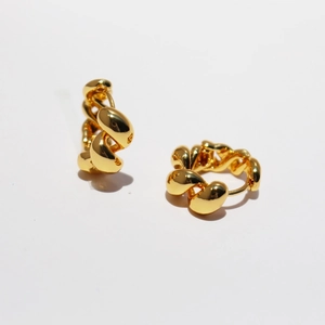 Chic gold-colored twisted hoop earrings with a metallic finish on a white background