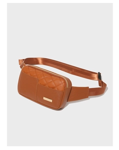 Detail of brown quilted faux leather waist bag with gold zipper and adjustable strap