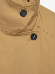 Detail of khaki trench coat collar and black button with high-quality twill fabric texture