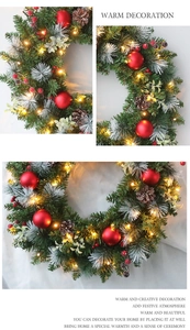 Detailed view of Christmas wreath featuring red berries, pine cones and warm LED lights