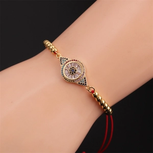 Bracelet réglable en perles dorées avec œil turc en zircon sur cordon rouge