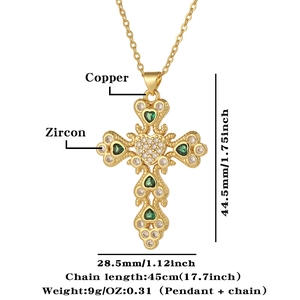 Detail of gold-plated copper cross pendant featuring green and white cubic zirconia