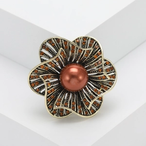 Retro hollow flower brooch with orange rhinestones and a brown pearl in antique gold