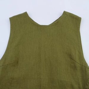 Detailed close-up of olive green linen sleeveless midi dress fabric texture and neckline