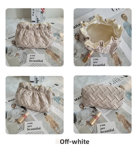 Detail view of beige corduroy cosmetic bag with pearl zipper and woven pleated texture