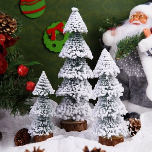 Set of three mini snow-covered Christmas trees with wooden bases for festive tabletop decor