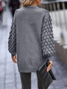 Detail of grey V-neck knit cardigan showing unique leaf-like texture on sleeves