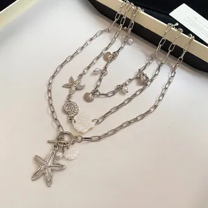 Bohemian multi-layer necklace with sea shells, stars, and pearls in silver finish