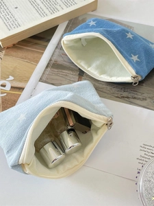 Denim star print pouches in navy and light blue for makeup and travel storage