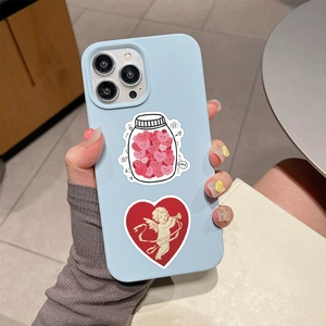 Close-up of light blue phone case with heart stickers and cupid print design
