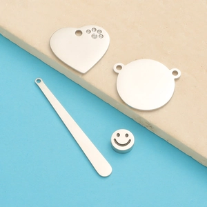 Detailed silver stainless steel accessories with heart charm and smiley face bead