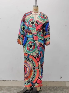 Close-up of vibrant mandala print and large lapel on this long bohemian trench coat