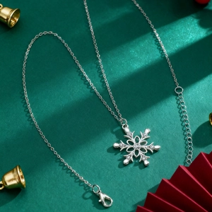 Detail shot of a silver snowflake necklace with sparkling zircons on festive background