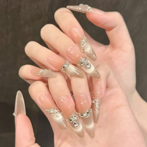 Elegant champagne cat-eye stiletto press-on nails with silver glitter and pearl accents