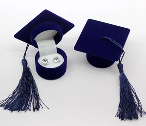 Macro detail of dark blue velvet doctoral cap jewelry box with tassel and earring insert