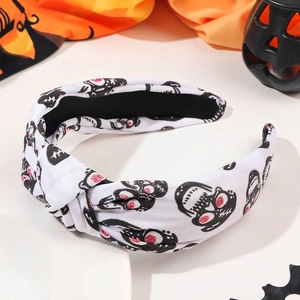 Detail of Halloween knotted headband with skull patterns and pearl rhinestone accents