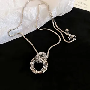 Minimalist silver multi-layered circular pendant necklace with sleek snake chain design