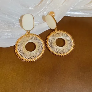 French palace style dreamcatcher drop earrings with white enamel and gold woven circles