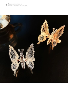 Detailed view of hollow butterfly hair clips in gold and silver with elegant tassels