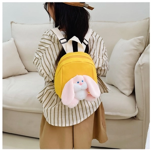 Detail of yellow toddler backpack with long-eared plush bunny doll and adjustable straps