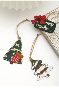Detail of wooden Christmas tree gift tags in red, white and green with hemp rope hangers