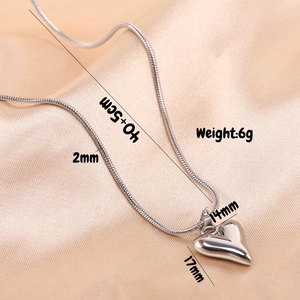 Detail view of 17mm silver heart pendant necklace on silk with dimensions and weight info