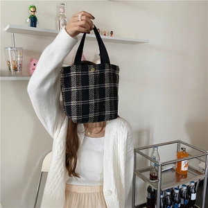 Lifestyle view of a vintage checkered wool lunch bag with a minimalist bento design