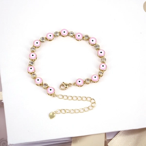 Bohemian gold evil eye bracelet with pink enamel and sparkling zircon stones