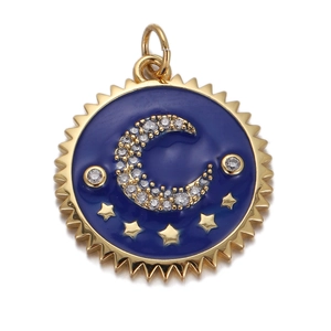 Macro shot of gold pendant featuring a crescent moon and stars on deep blue enamel