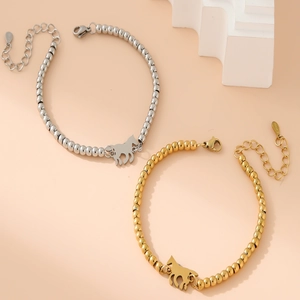 Detail of stainless steel bead bracelets with horse charms in gold and silver finish