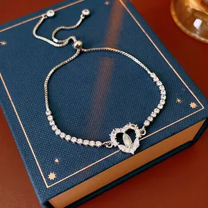 Adjustable silver heart bracelet with sparkling zircon stones and religious medal icon