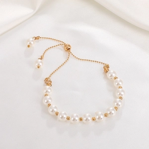 Elegant white pearl and gold bead bracelet with adjustable bolo closure for girls